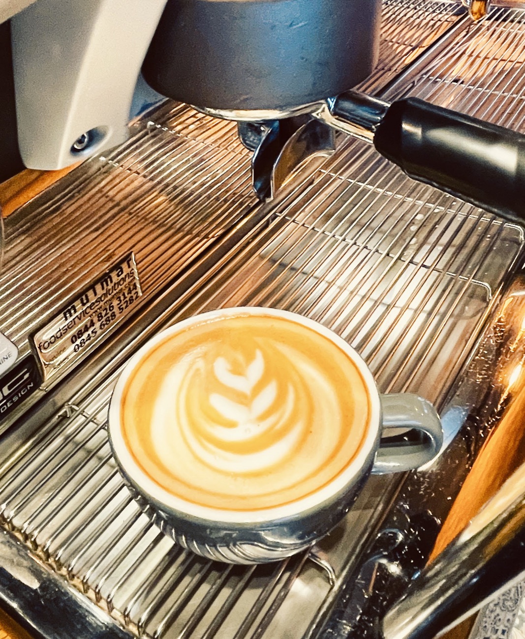 A cappuccino with leaf latte art on the espresso machine at Milk, Walthamstow